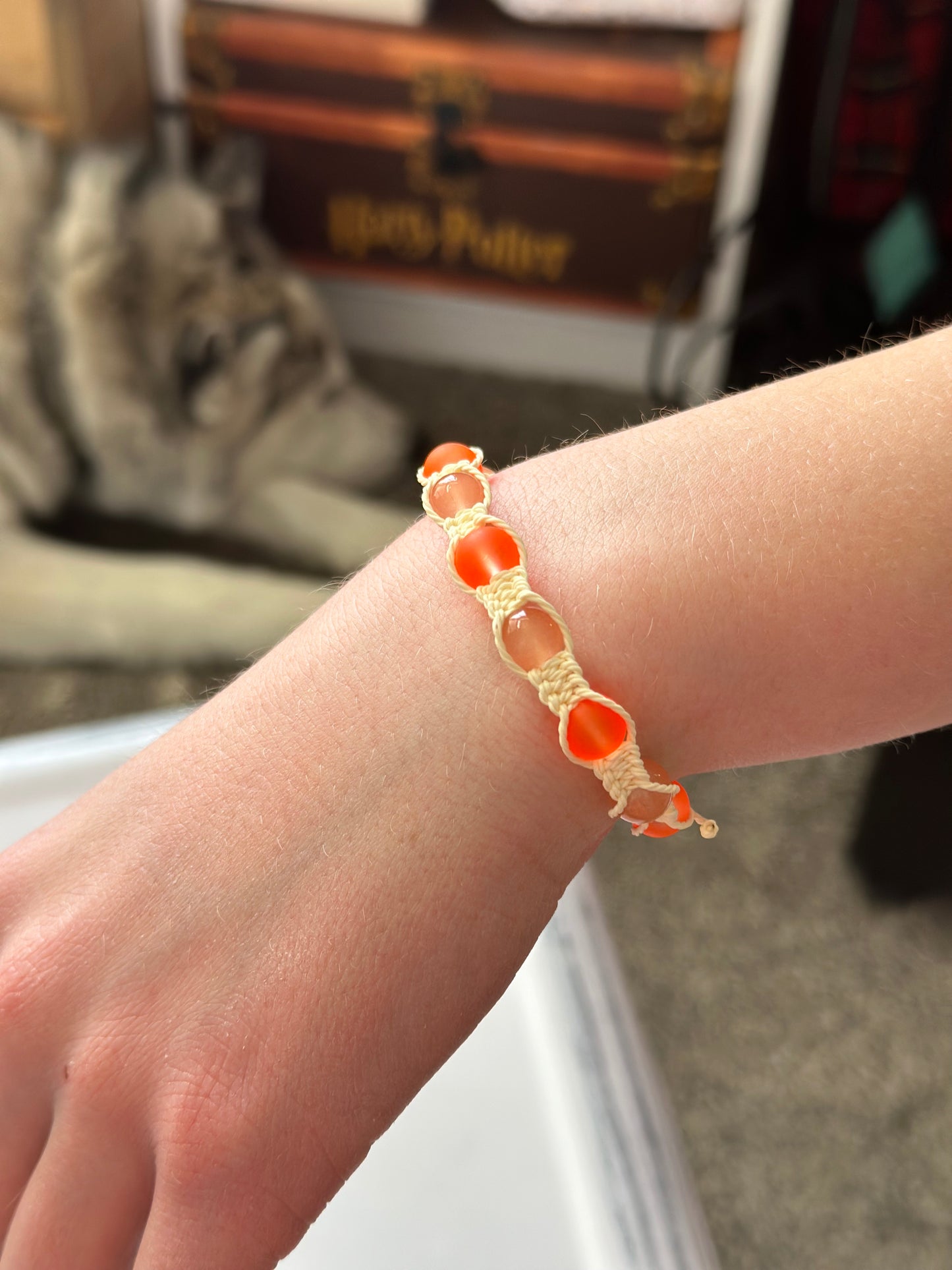 This SUNSET ORANGE BRACELET features an adjustable tie cord and a convenient on and off design, adding a stylish touch with its vivid sunset orange beads. Handmade jewelry that is fun and unique.